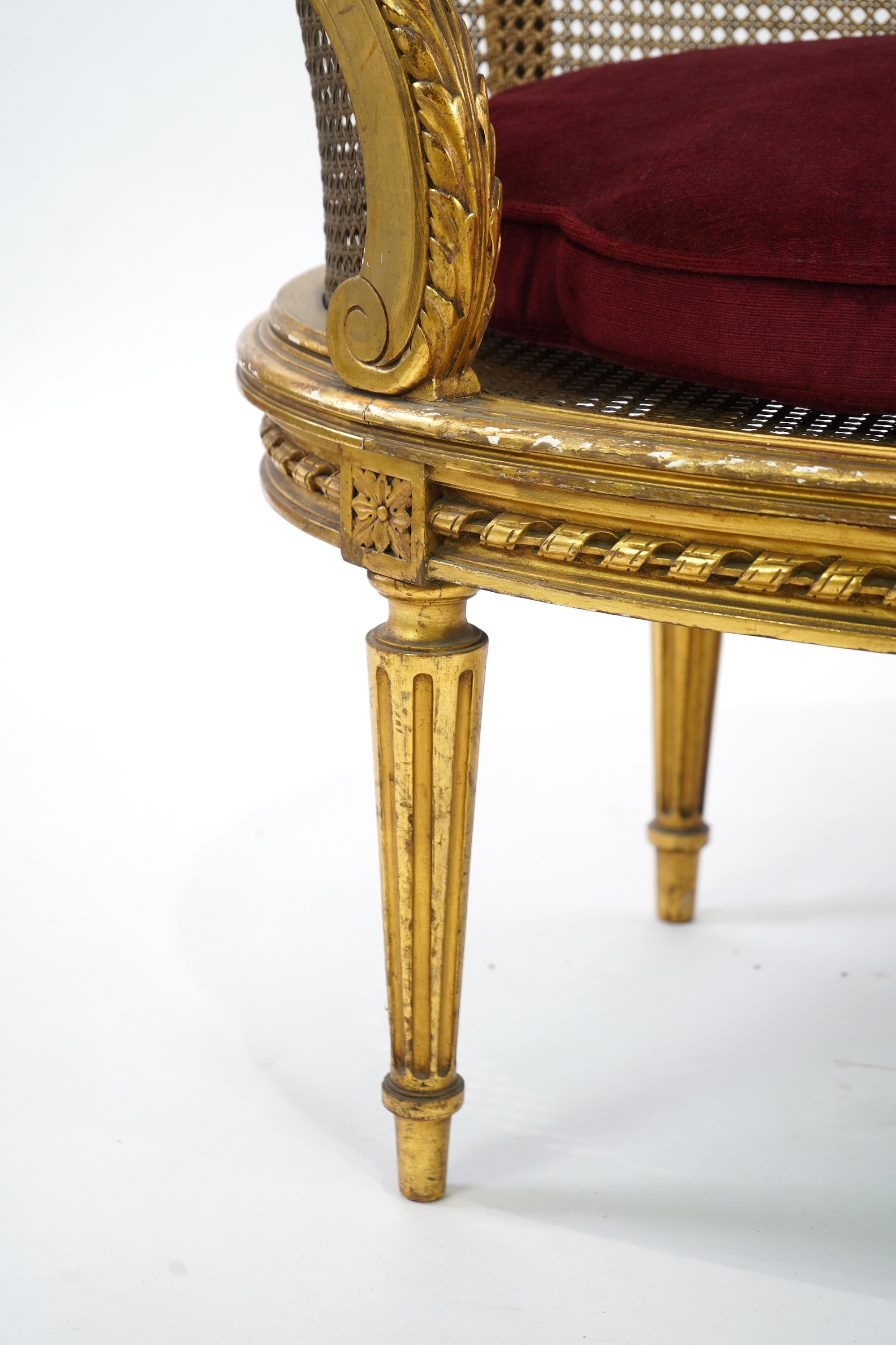 A late 19th / early 20th century French caned giltwood and composition canapé